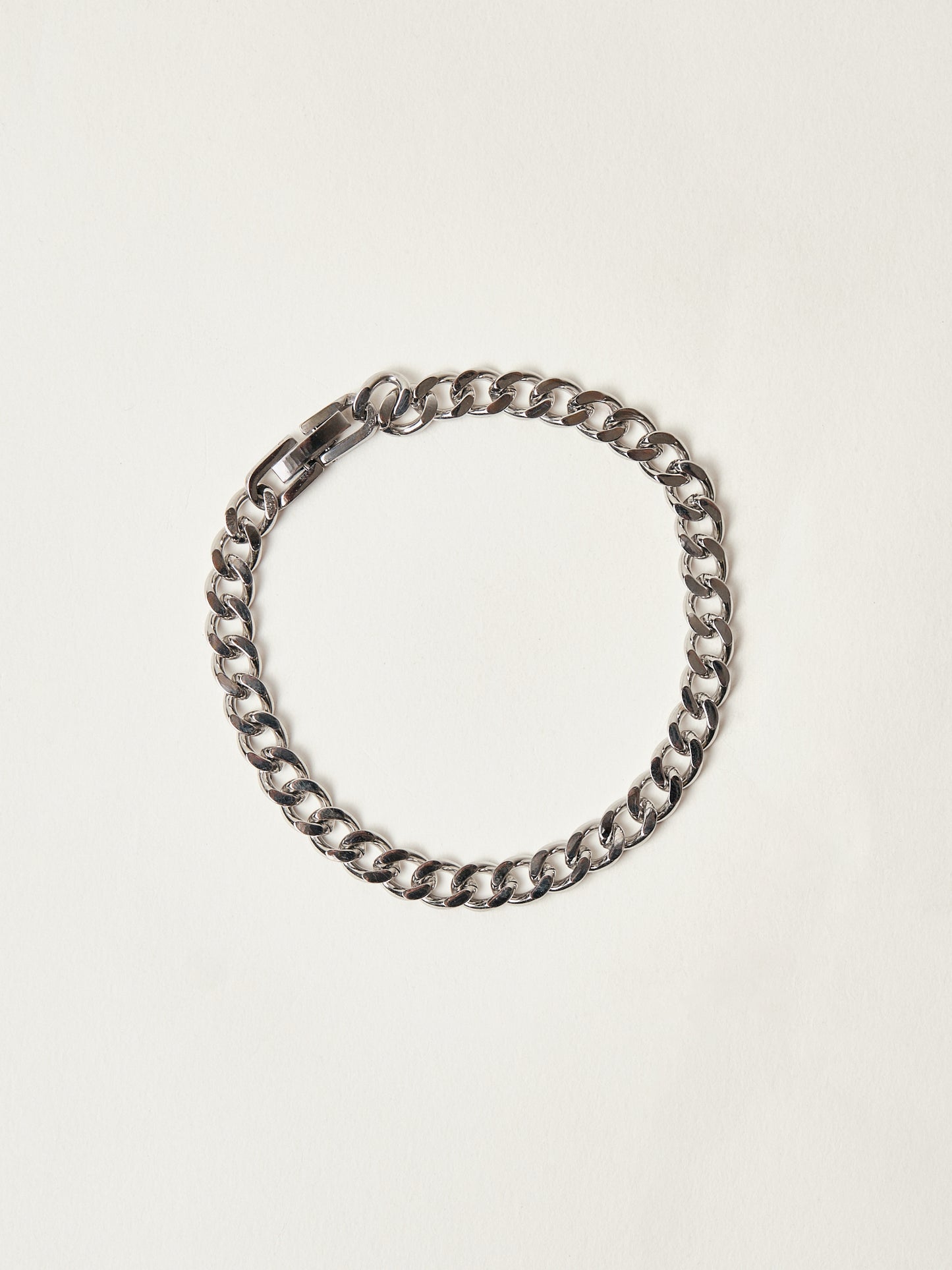 Silver chain bracelet on a light beige background