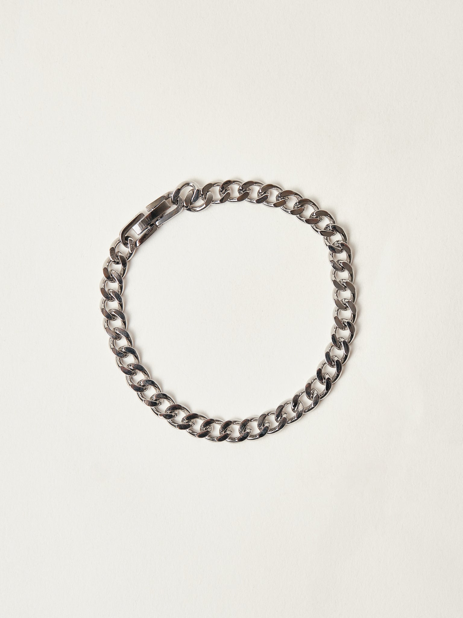 Silver chain bracelet on a light beige background