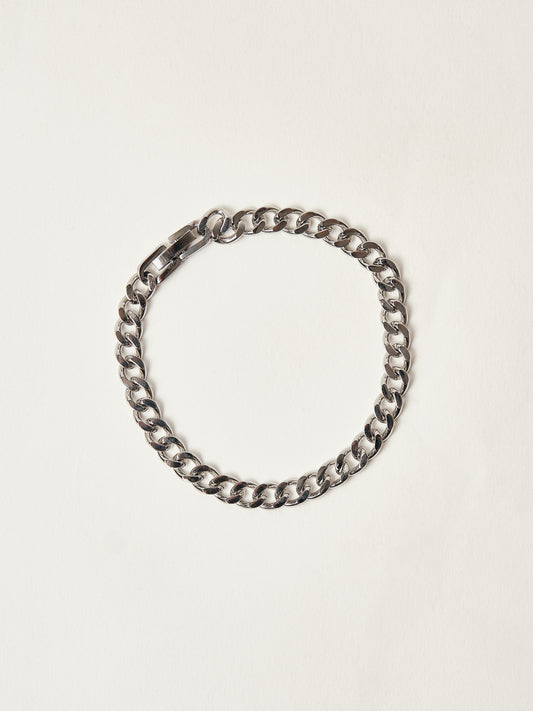 Silver chain bracelet on a light beige background