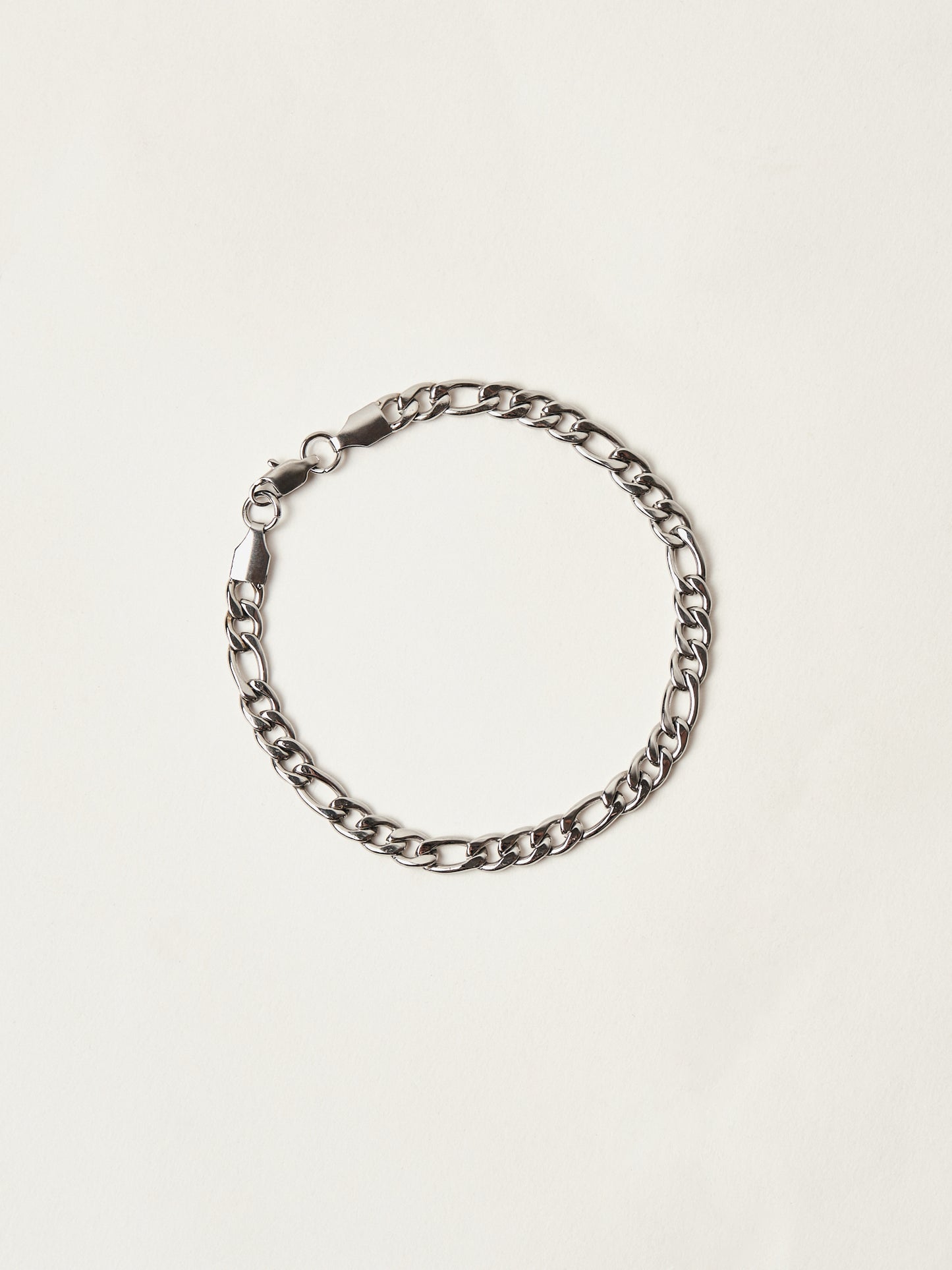 Silver chain bracelet on a light beige background