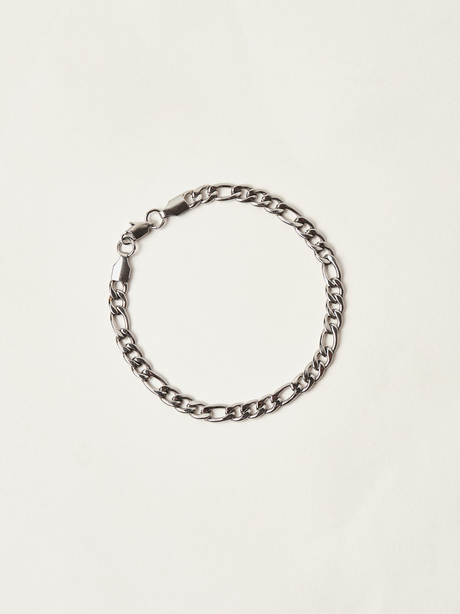 Silver chain bracelet on a light beige background