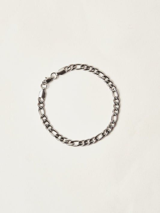 Silver chain bracelet on a light beige background