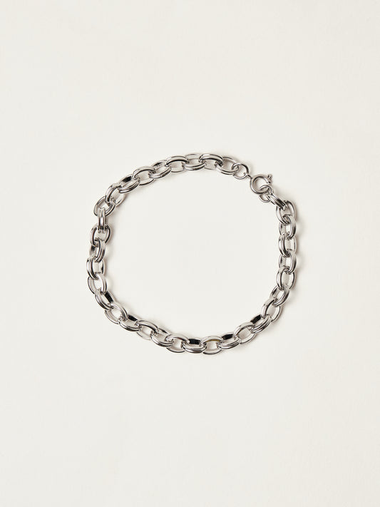 Silver chain bracelet on a light beige background