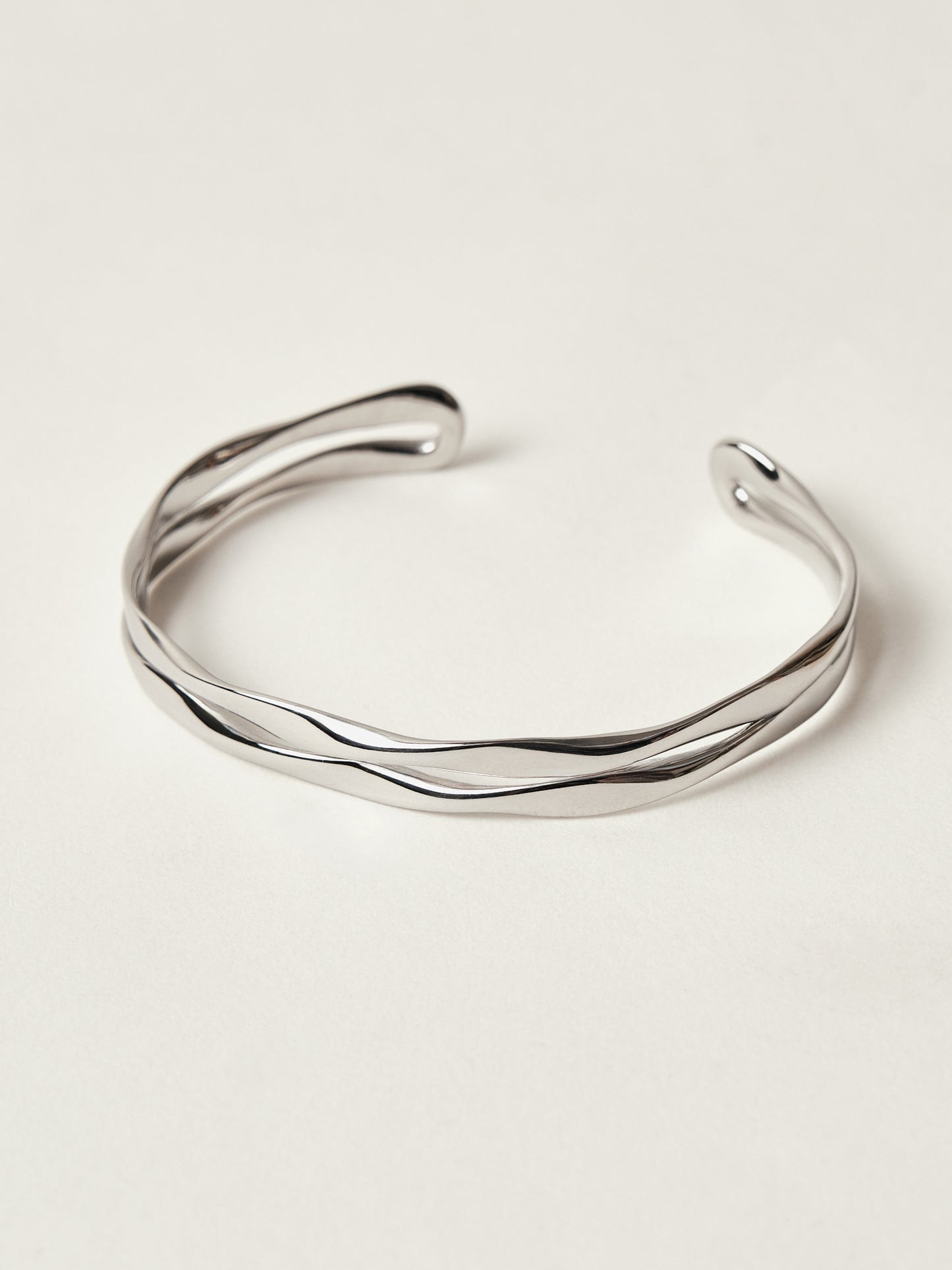 Silver bracelet on a light beige background