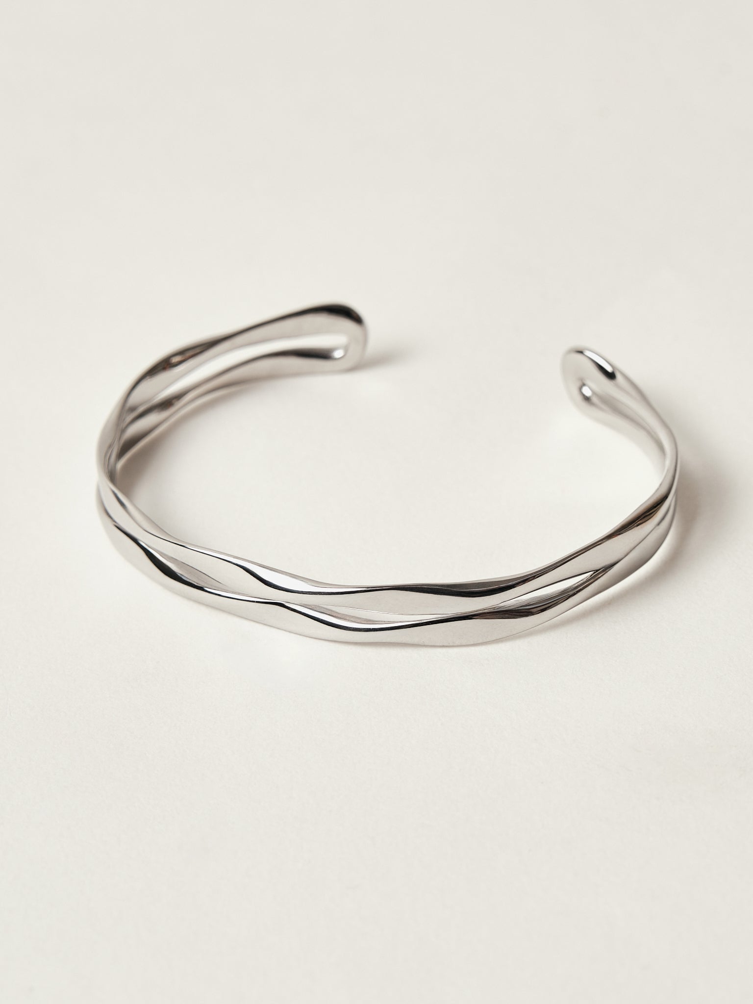 Silver bracelet on a light beige background