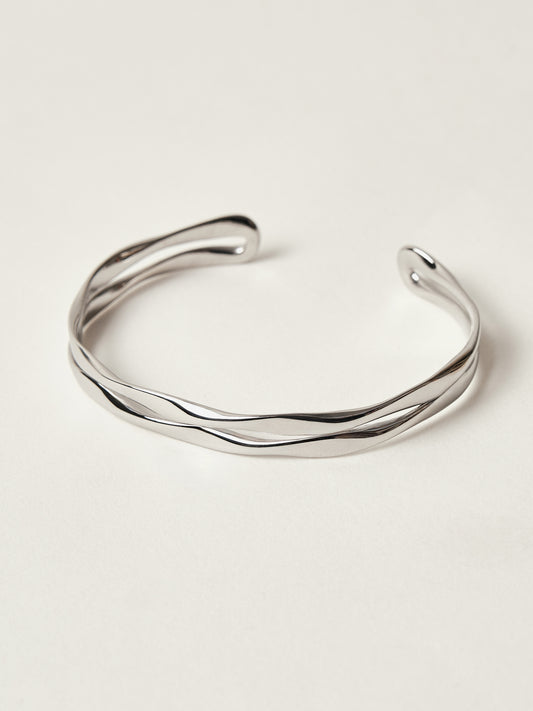 Silver bracelet on a light beige background