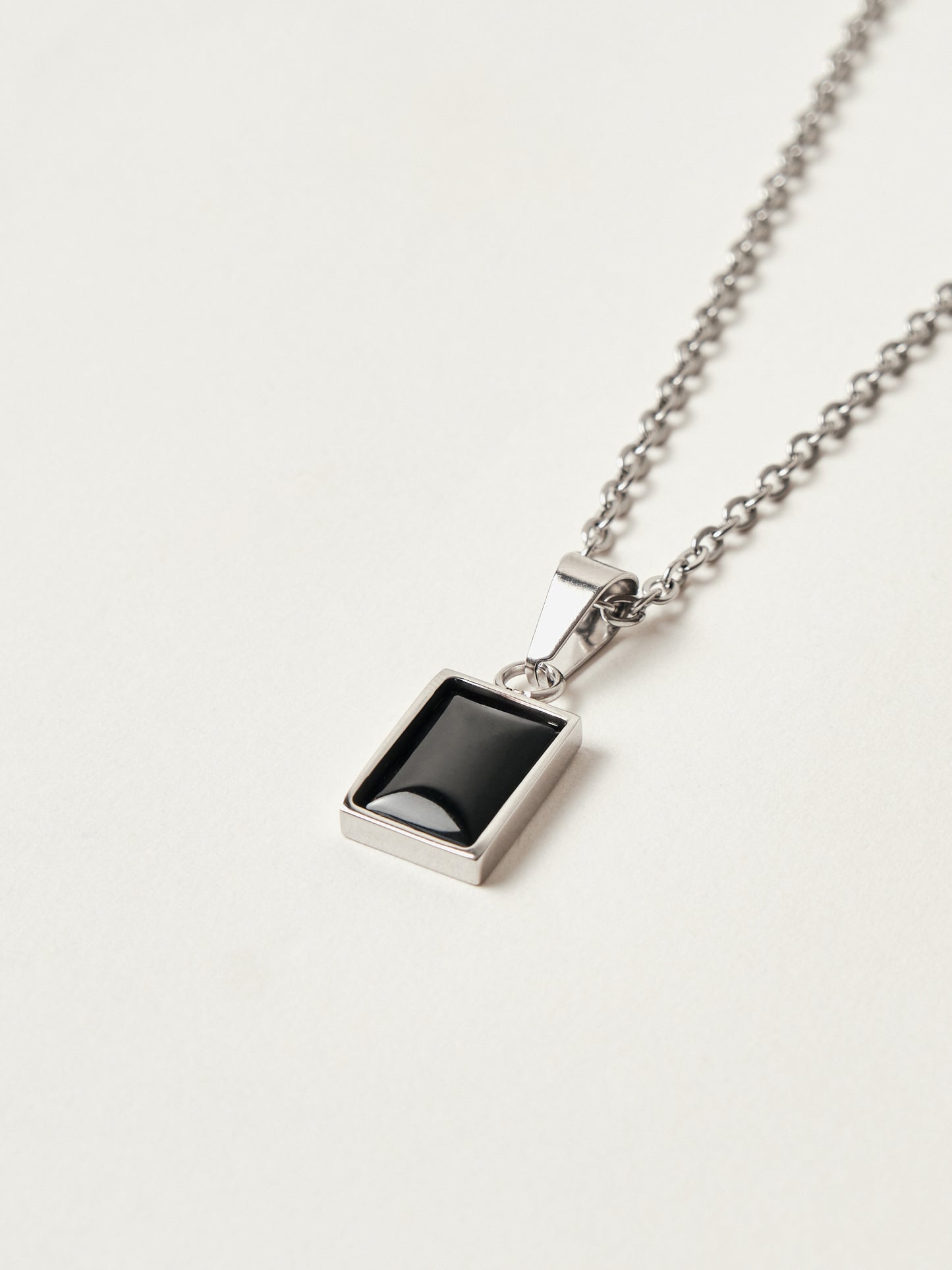 Necklace with a rectangular pendant on a light gray background