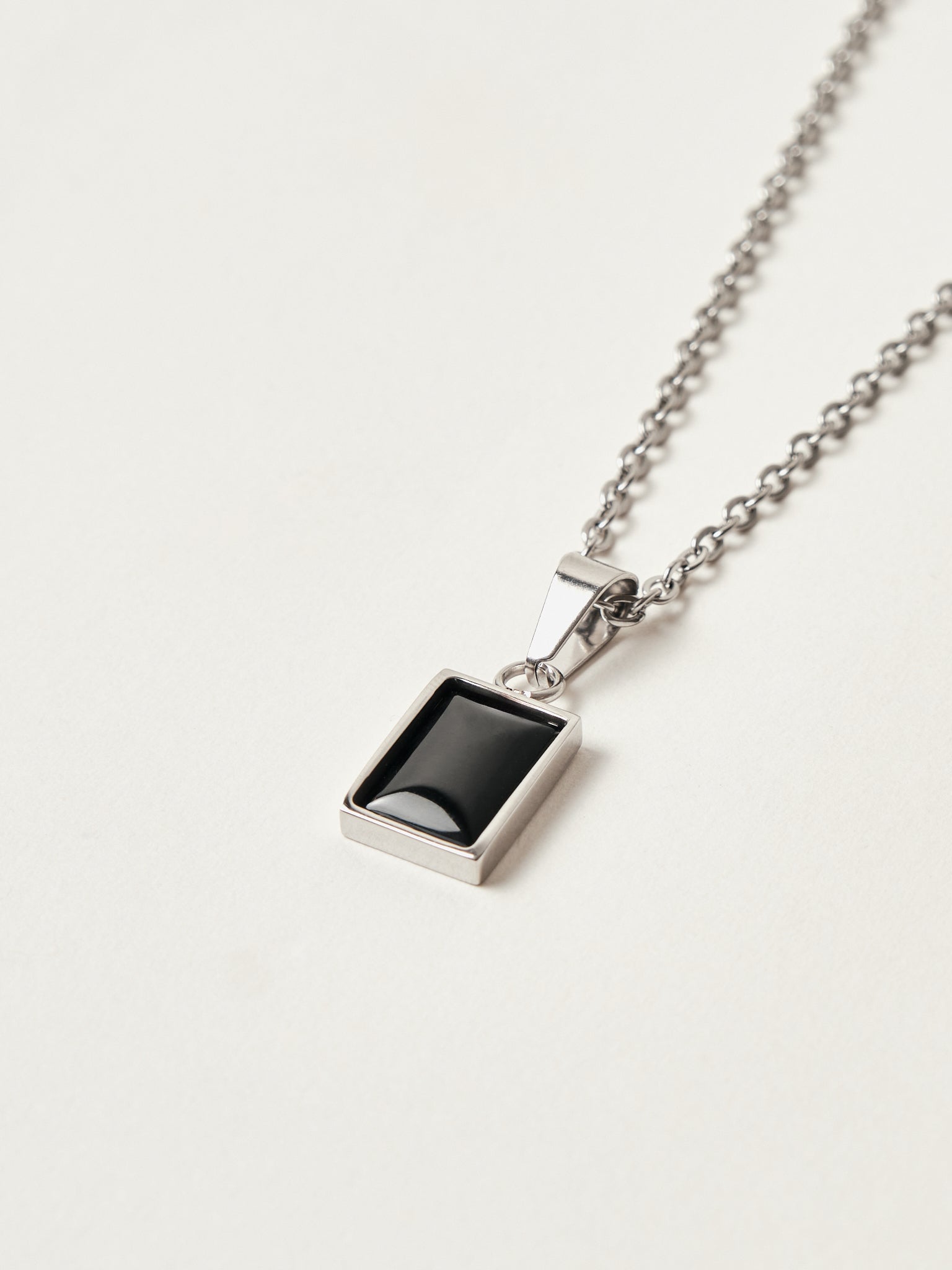 Necklace with a rectangular pendant on a light gray background
