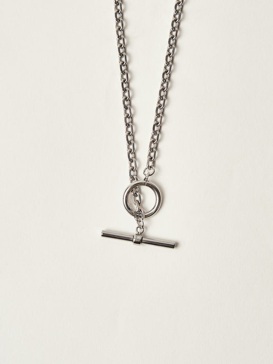 Silver necklace with a pendant on a light gray background