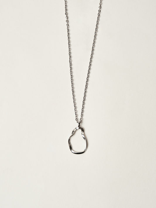 Silver necklace with a unique pendant on a light beige background