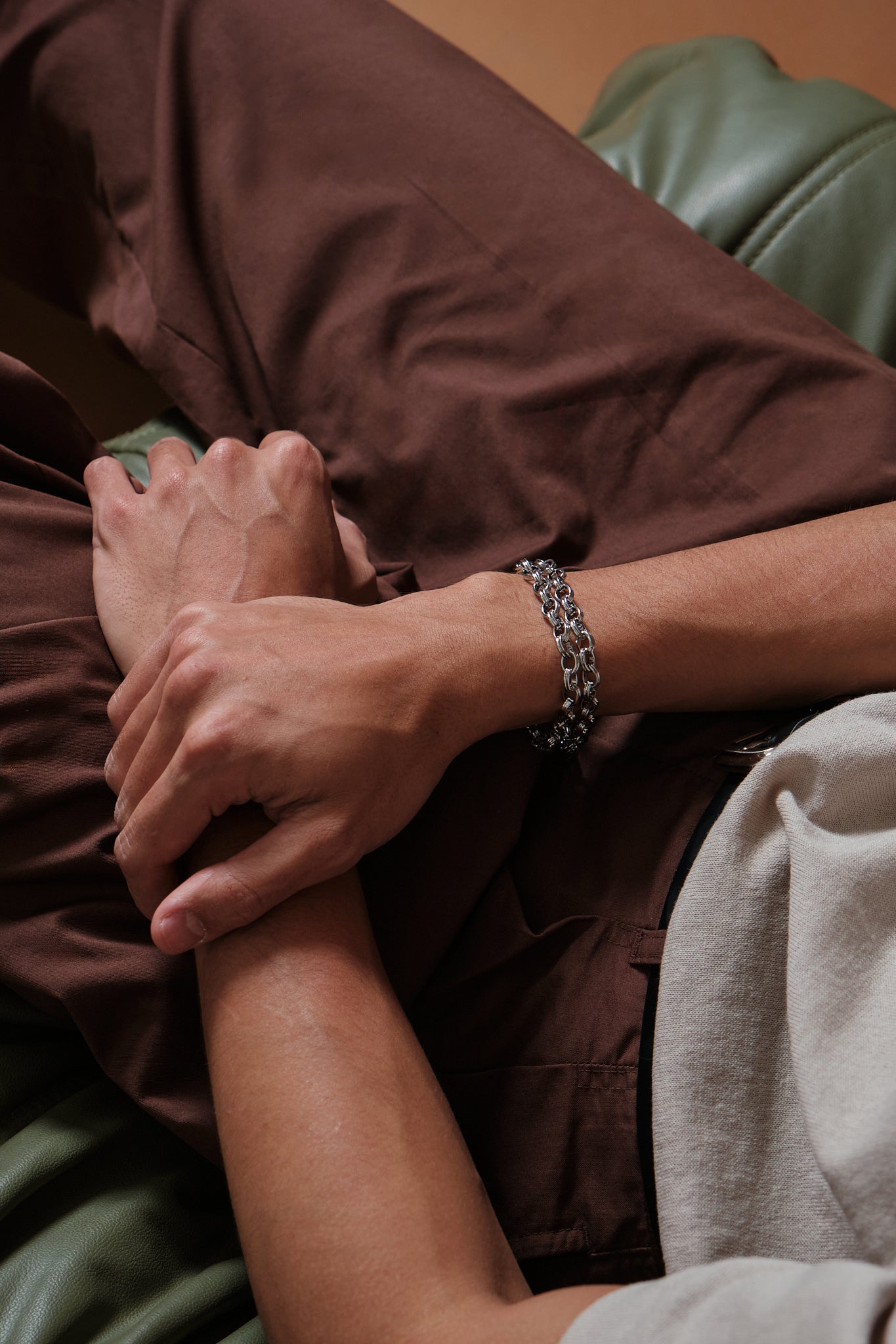 Close-up of a person's hand holding another person's foot, with a focus on the interaction between the two.